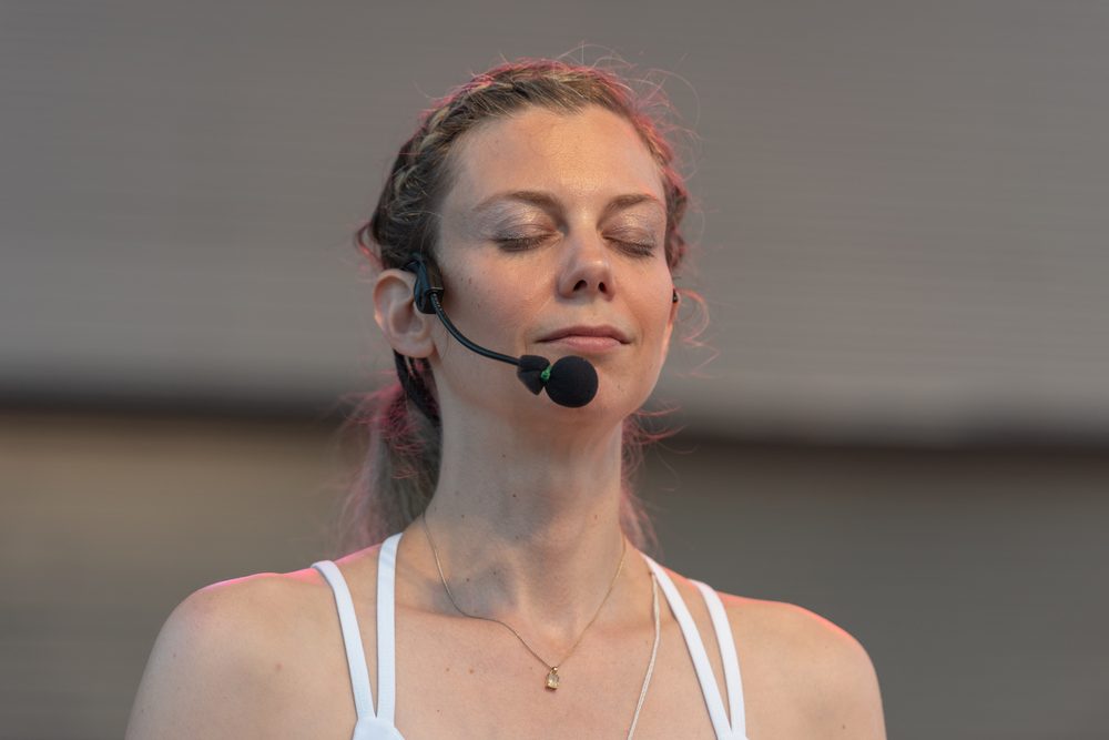Julia Arbuckle seated in practice, one hand raised mid-gesture.